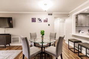 a dining room with a glass table and chairs at Bright 2 bedroom 2 bath condo with pool in Sarasota