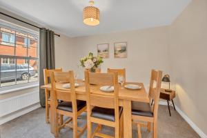 a dining room with a wooden table and chairs at The Grange Luxe2, 5 Bedroom House,Spacious,contractor,family,Internet,free parking,group,study,relocation,easily accessible in Ipswich,Kesgrave in Ipswich