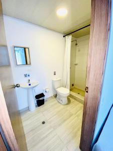 a bathroom with a toilet and a sink at BLUE ISLAND HOTEL in San Andrés