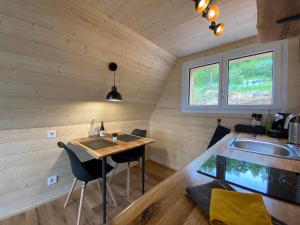 a small kitchen with a table in a tiny house at Hengifosslodge Tiny Houses in Egilsstadir