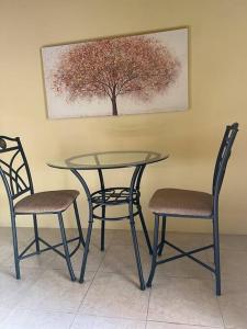 2 sillas y mesa de cristal con mesa y 2 sillas en Emperor’s place Garvey mead, en Portmore