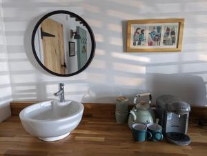 a bathroom with a sink and a mirror at Sunrise Studio in Colchester