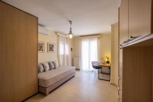 a bedroom with a bed and a desk in a room at ioli Corfu maisonette in Kastanéa +34 photos