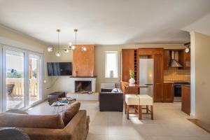 a living room with a couch and a table at ioli Corfu maisonette in Kastanéa