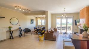 a living room with a couch and a table at ioli Corfu maisonette in Kastanéa