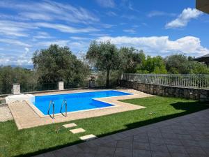 a swimming pool in the middle of a yard at ioli Corfu maisonette in Kastanéa