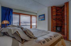 a bedroom with a bed with a view of a mountain at 207 Point Dillon in Dillon +18 photos