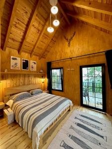 a bedroom with a large bed in a wooden room at Varya Tatil Köyü in Çamlıhemşin