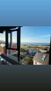 a view of a city from a window of a building at DÚPLEX DE LUJO EN FOZ CON VISTAS al MAR in Foz