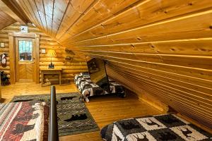 a log cabin bedroom with a large wooden ceiling at Pine Cone Cabin in Gatlinburg