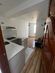 a kitchen with a sink and a counter top at Hotel SOGU TOWER in Ayacucho