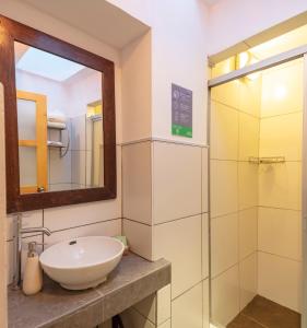 a bathroom with a sink and a glass shower at SAMANA B&B in Cusco