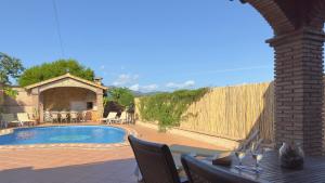 a patio with a fence and a swimming pool at Chalet El Parral - Piscina y Sala de Cine in Málaga