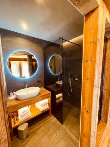 a bathroom with a sink and a mirror at Hotel Piccolo Tibet in Livigno