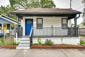 a small white house with a blue door at WFH-Friendly Tampa Home Rental 2 Mi to Downtown! in Tampa