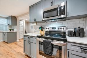 a kitchen with a stove and a microwave at WFH-Friendly Tampa Home Rental 2 Mi to Downtown! in Tampa