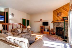 a living room with a couch and a fireplace at B-101 Buffalo Ridge in Silverthorne