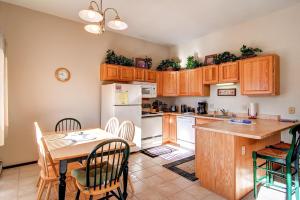 a kitchen with wooden cabinets and a table with chairs at B-101 Buffalo Ridge in Silverthorne
