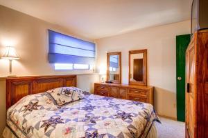 a bedroom with a bed and a dresser and a window at B-101 Buffalo Ridge in Silverthorne