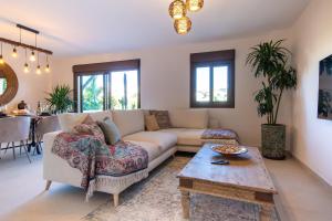 a living room with a couch and a table at Villa close to the beach. in Mijas