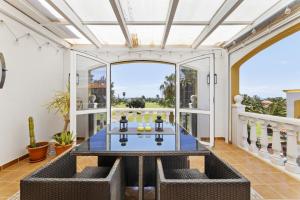 an open living room with a table and a large window at Casahost Fuerteventura Golf in La Guirra