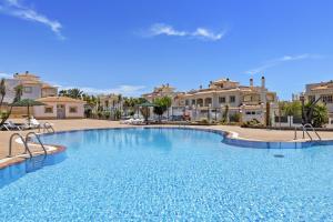 a large swimming pool in front of some houses at Casahost Fuerteventura Golf in La Guirra