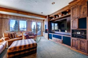 uma sala de estar com um sofá e uma televisão em Three Peaks Mountain Lodge em Silverthorne