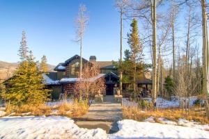 a house in the winter with snow on the ground at Three Peaks Mountain Lodge in Silverthorne