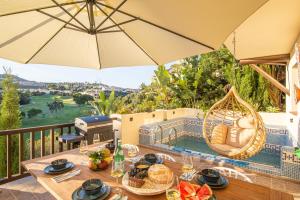 a patio with a table and an umbrella at Villa close to the beach. in Mijas