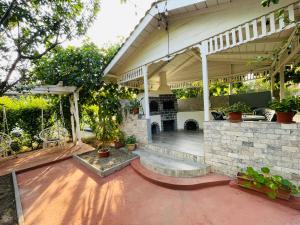 an outdoor patio with a stone wall at Vila Timona in Eforie Nord