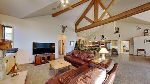 a living room with leather couches and a flat screen tv at 36 James Court in Dillon