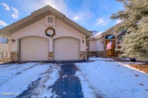a house with two garage doors in the snow at 36 James Court in Dillon