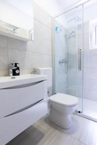 a white bathroom with a toilet and a shower at Apartments Lonzor I in Selce +42 photos