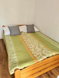 a bed with two pillows on top of it at Wczasy przy Młyńskiej 18 in Sarbinowo