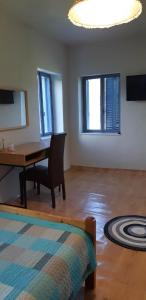 a room with a desk and a chair and a table at Κτήμα Μύλος (Κτήμα στη Φύση) in Agrinio