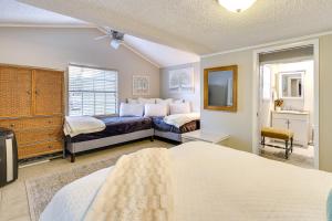 a bedroom with two beds and a tv at Waterfront Home with Dock in South Grand Lake! in Vinita