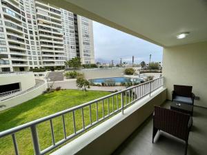 a balcony of a apartment with a view of a pool at Departamento Nuevo!!! Sector Residencial Ciudad Iquique in Iquique