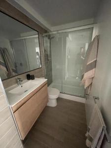 a bathroom with a sink and a toilet and a shower at Departamento Nuevo!!! Sector Residencial Ciudad Iquique in Iquique