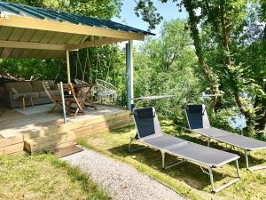 two chairs and a table on a deck at Chalet cosy bord de Seine 30min paris in Carrières-sous-Poissy