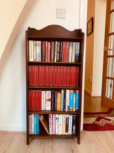 a book shelf filled with books next to a staircase at Leicester city centre flat in Leicester