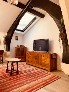 a living room with a television on a wooden dresser at Leicester city centre flat in Leicester