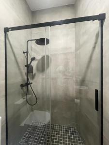 a shower with a glass door in a bathroom at APARTAMENTOS SOL Y LUNA in La Línea de la Concepción