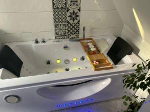 a white bath tub with a wooden box in it at GITE MA MAISON in Kintzheim
