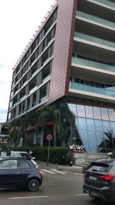 a large building with cars parked in front of it at Jovana ianua in Budva