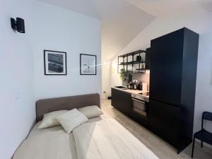 a bedroom with a bed and a black cabinet at Black n’ White in Dubrovnik