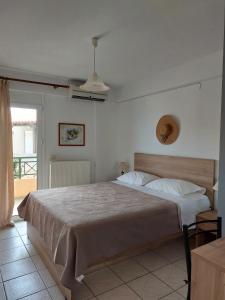 a bedroom with a large bed in a room at Minoica Beach Apartments in Amoudara Herakliou