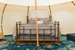 a bedroom with a bed in a tent at Smith Lake Farm in Merville