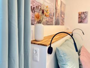 - une chambre avec un vase sur un comptoir en bois dans l'établissement Stilvolles Mikroapartment in Kehl Goldscheuer - 1A Guesthouse, à Kehl