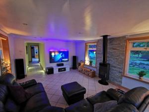 ein Wohnzimmer mit Couch und Flachbildfernseher in der Unterkunft Private peacefull pet friendly converted country cottage in Keig