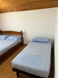 2 camas en una habitación con pared en Apartments Hotel AL&DE, en Velipojë